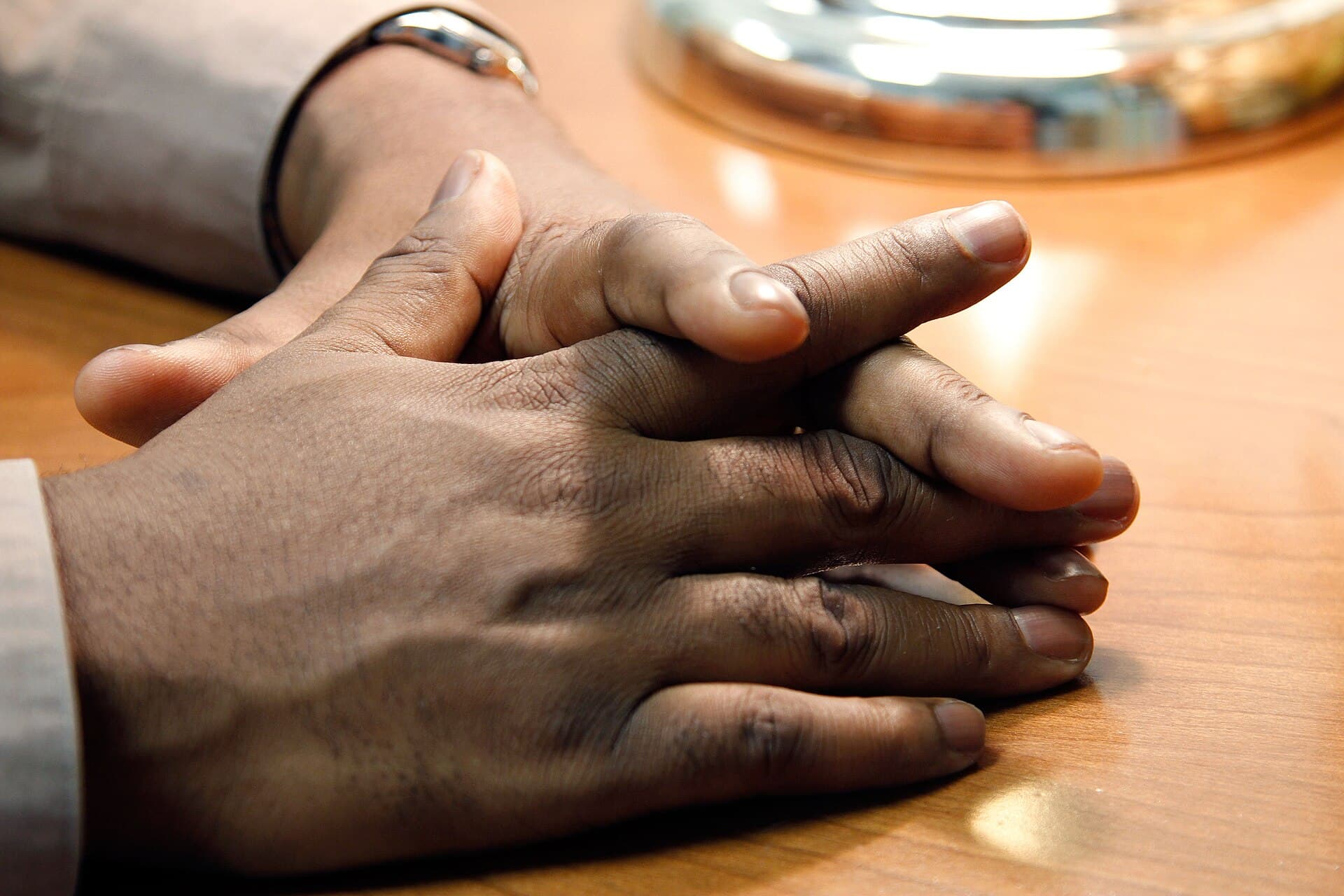 Two people holding hands during a conversation